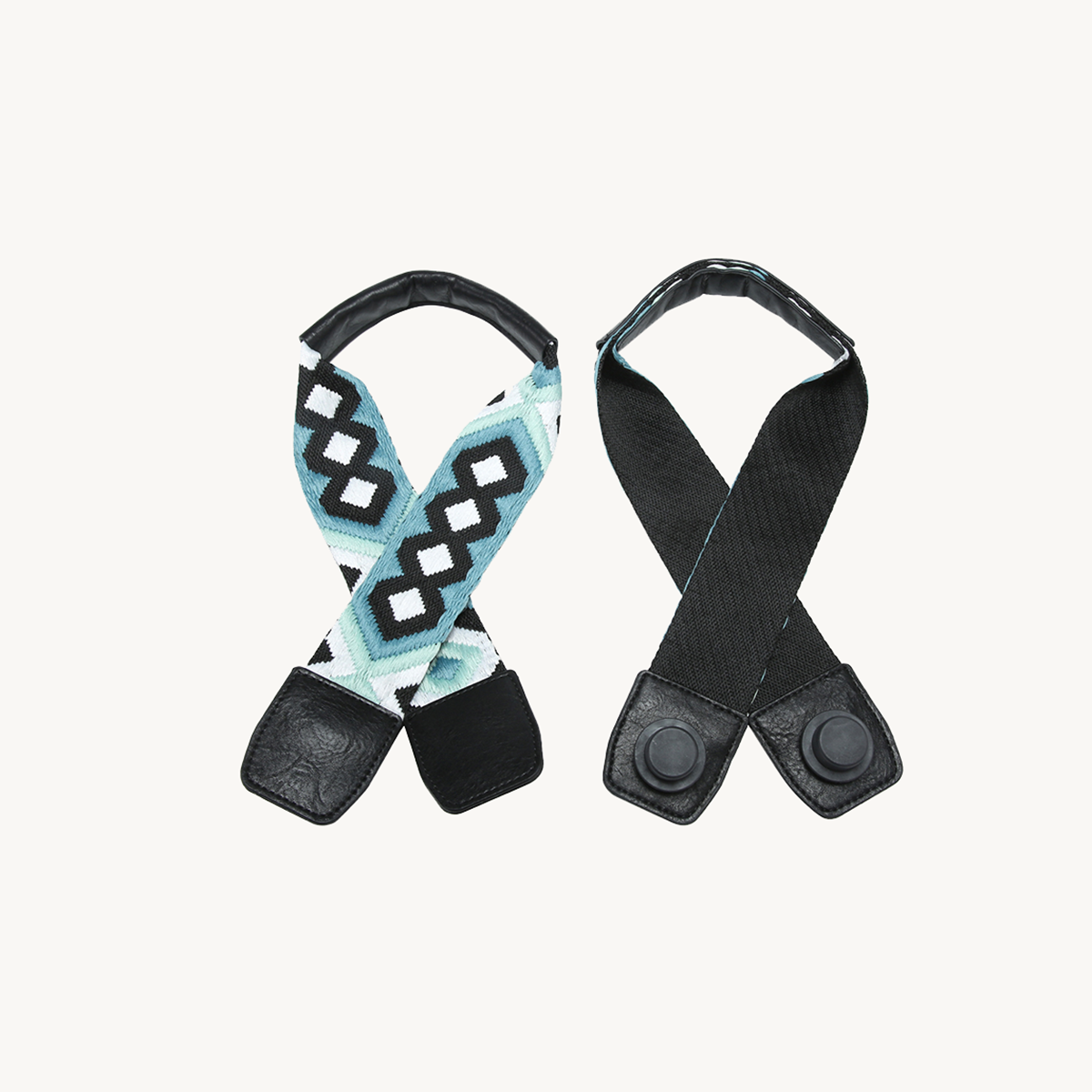 Teal geometric guitar strap and black strap, both with snap leather end pads